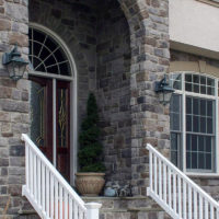 Stonecraft heritage pennsylvania facade around arc of front entrance on home