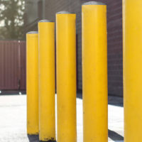yellow bollards protecting a building